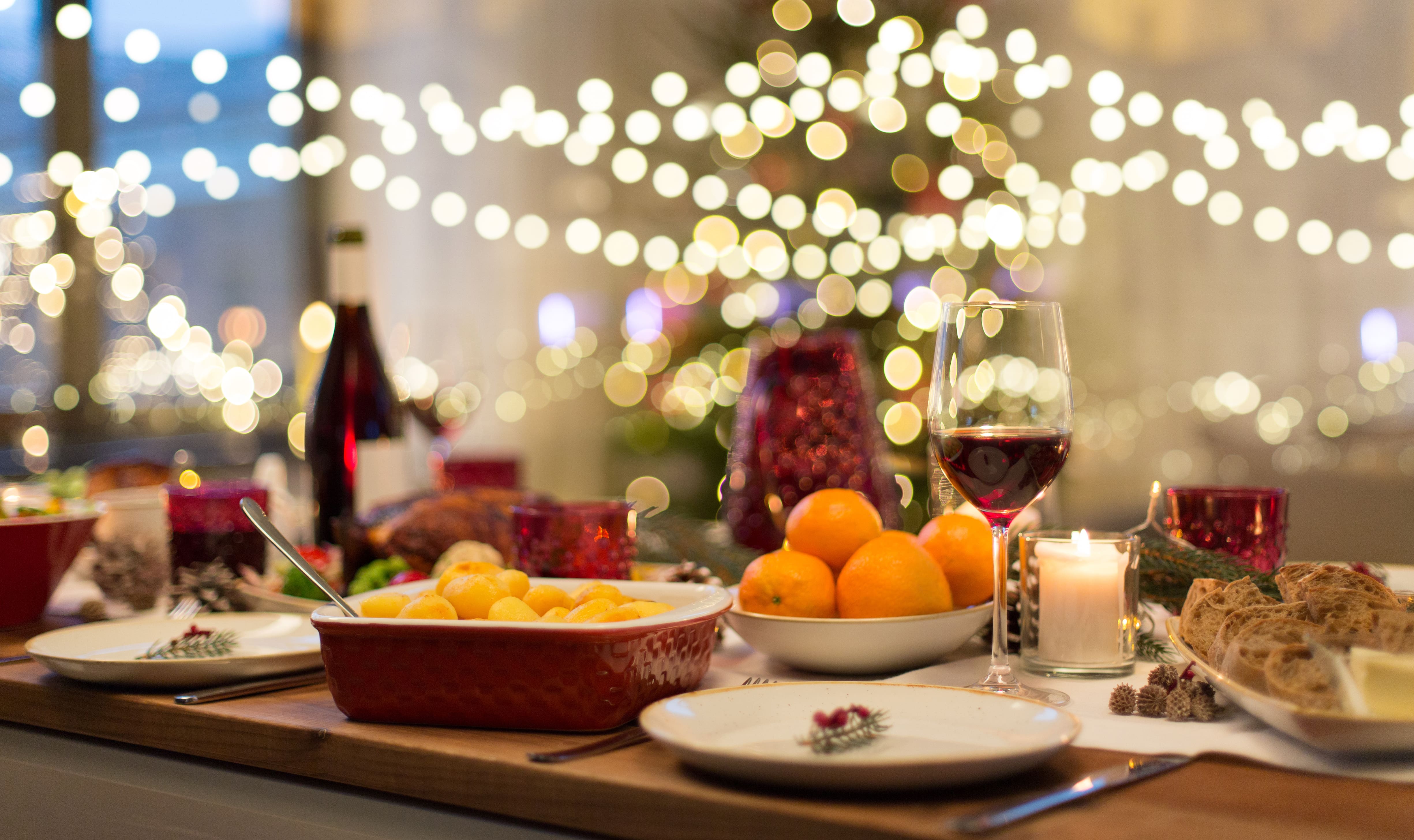 A table at Christmas bursting with festive flavours and adorned with fairy lights