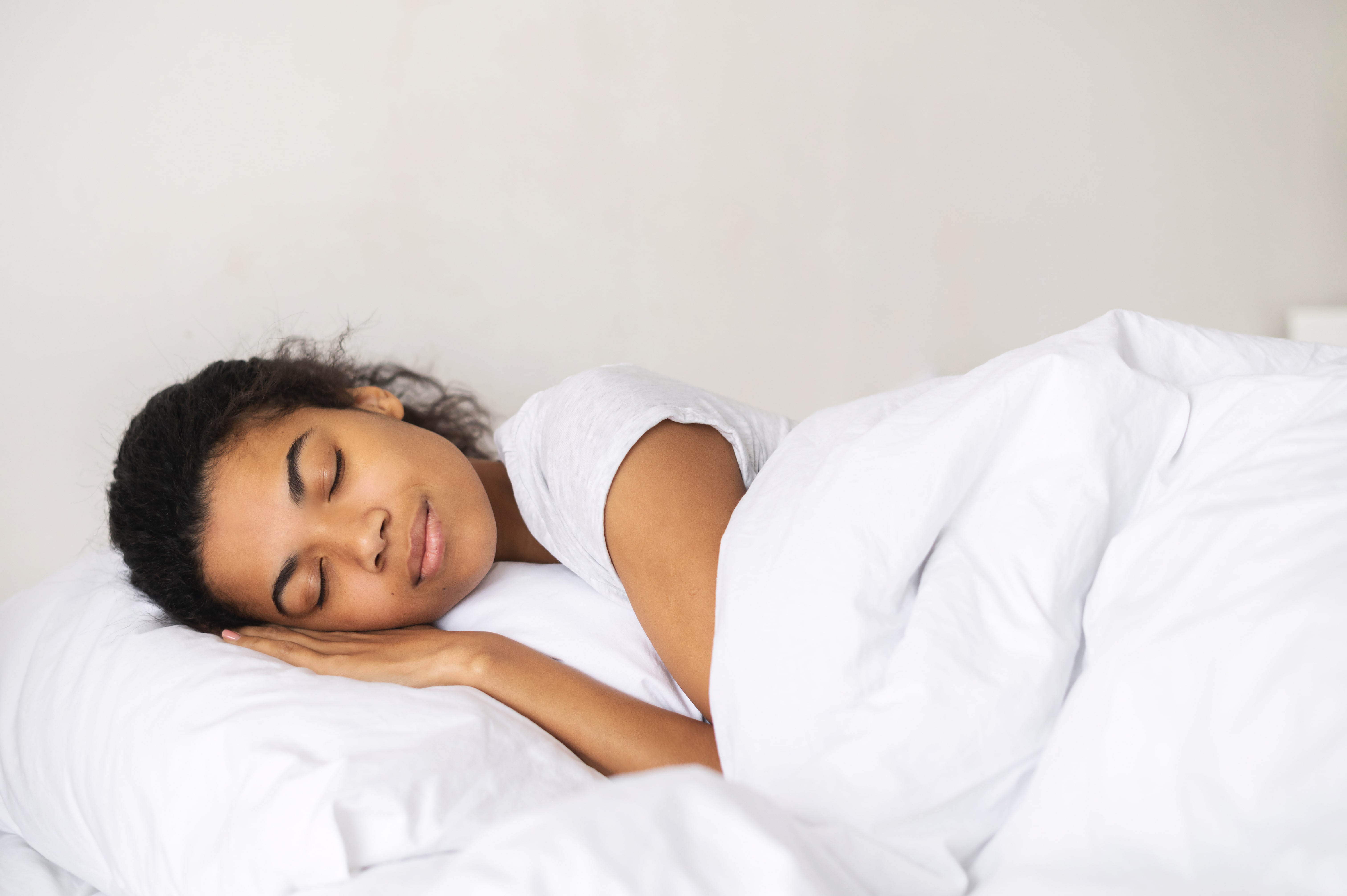 Woman sleeping contentedly on supportive pillow