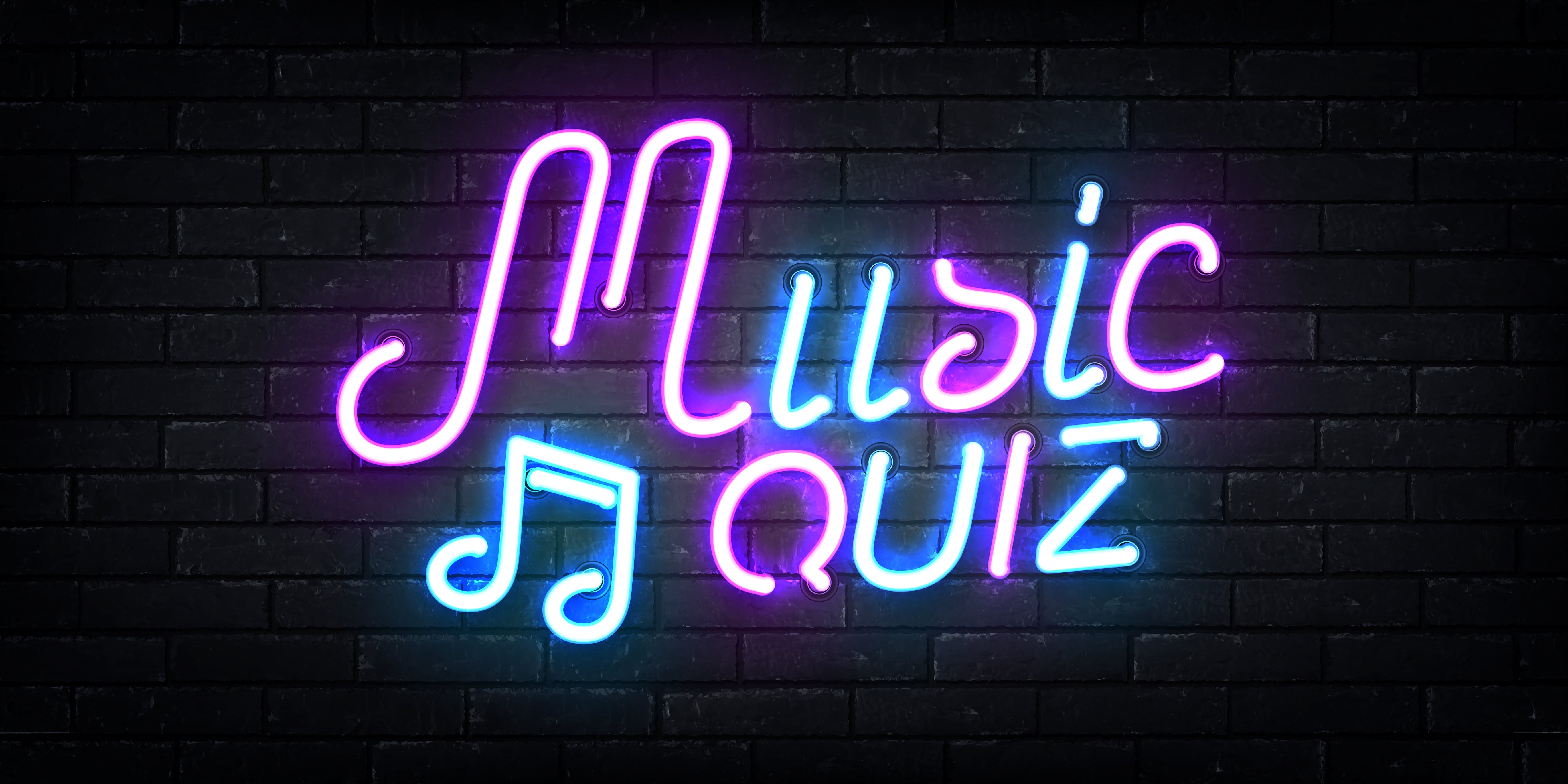 Music Quiz LED sign silhouetted against a painted black brick wall.