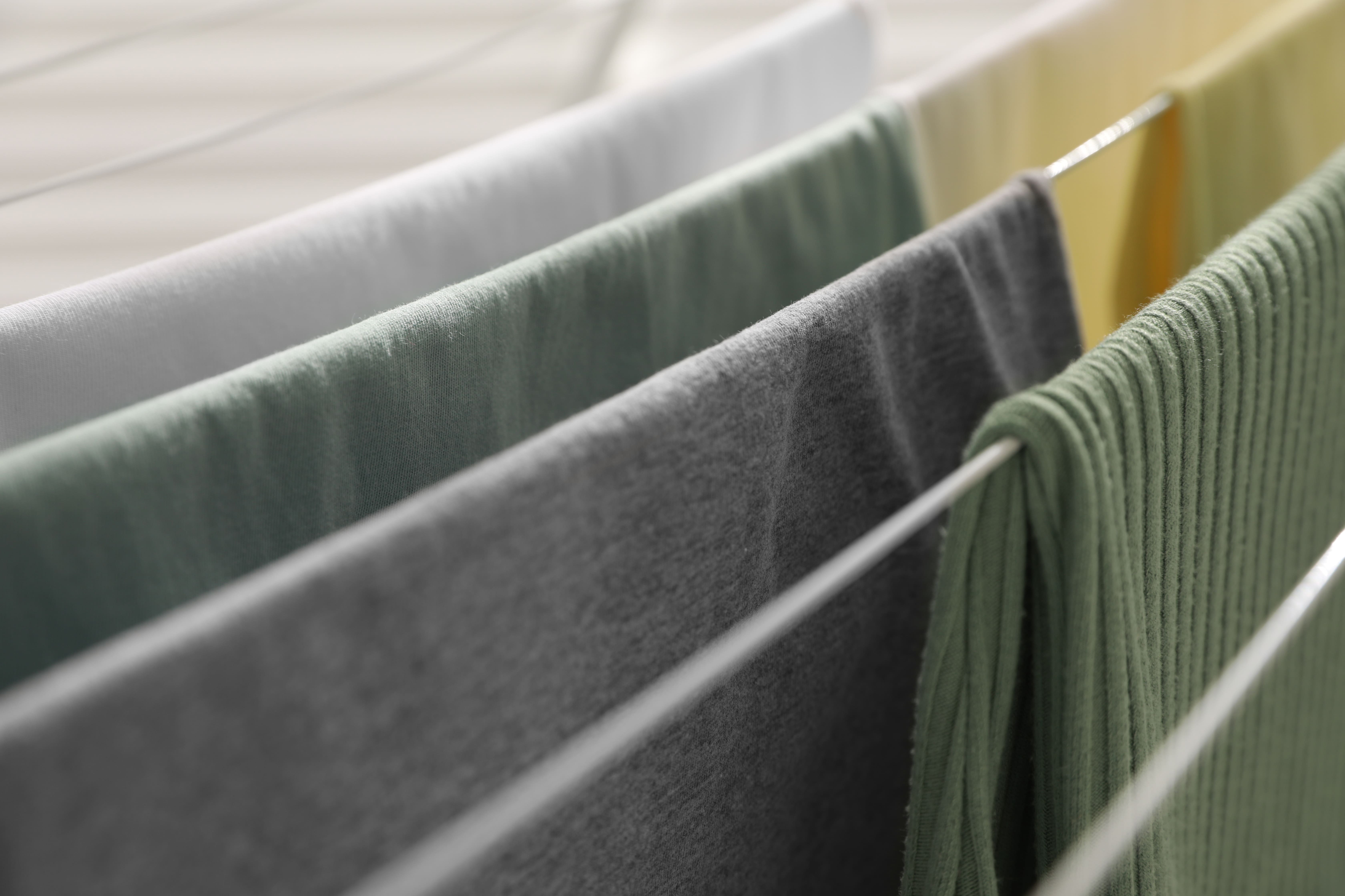 Washing and bedsheets drying on a collection of indoor washing lines