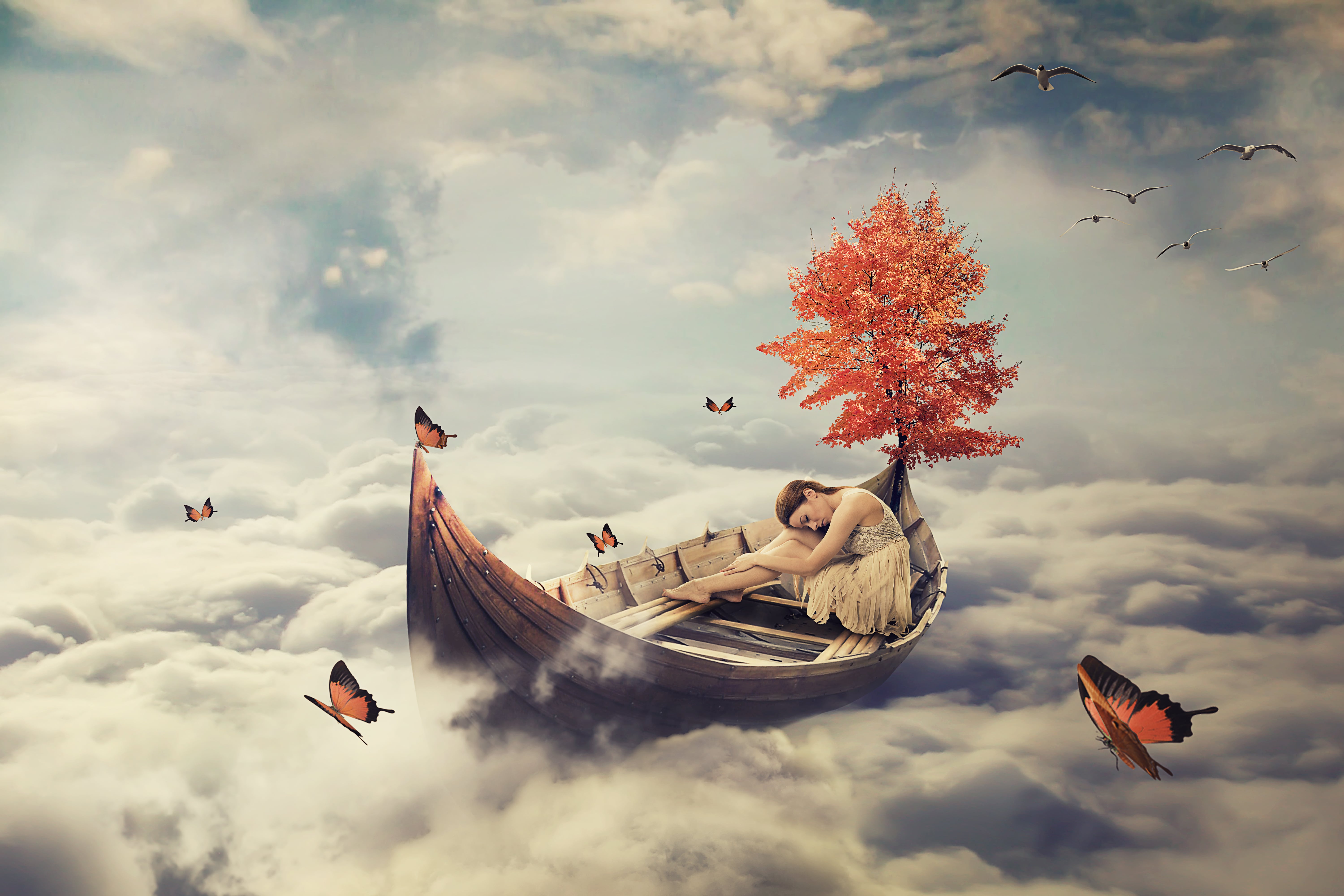 Image of a woman dreaming of being on a boat, floating through the clouds surrounded by butterflies