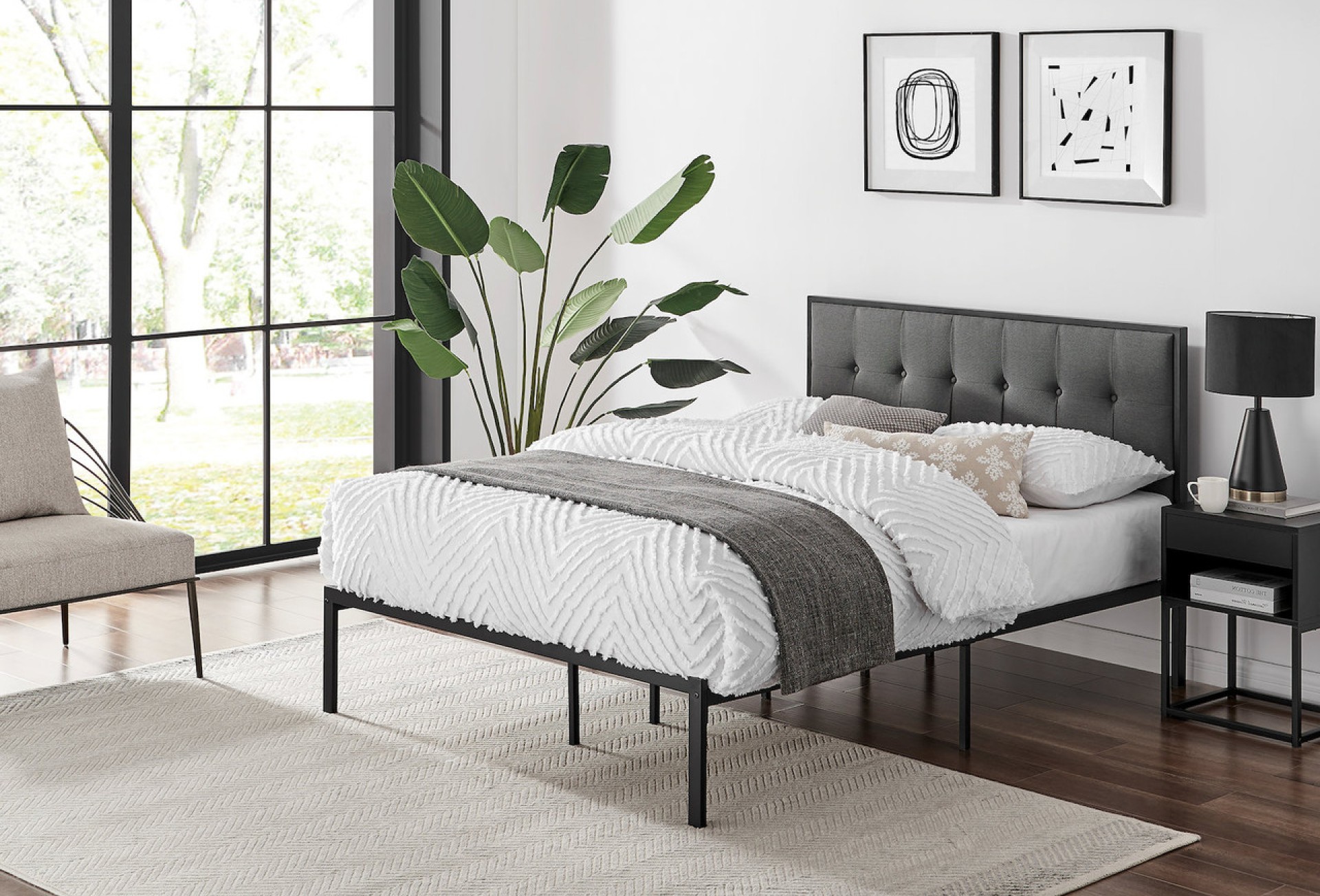 Maddison metal bed frame in back with grey upholstered headboard featuring button details