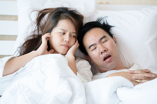 Snoring man keeping woman awake