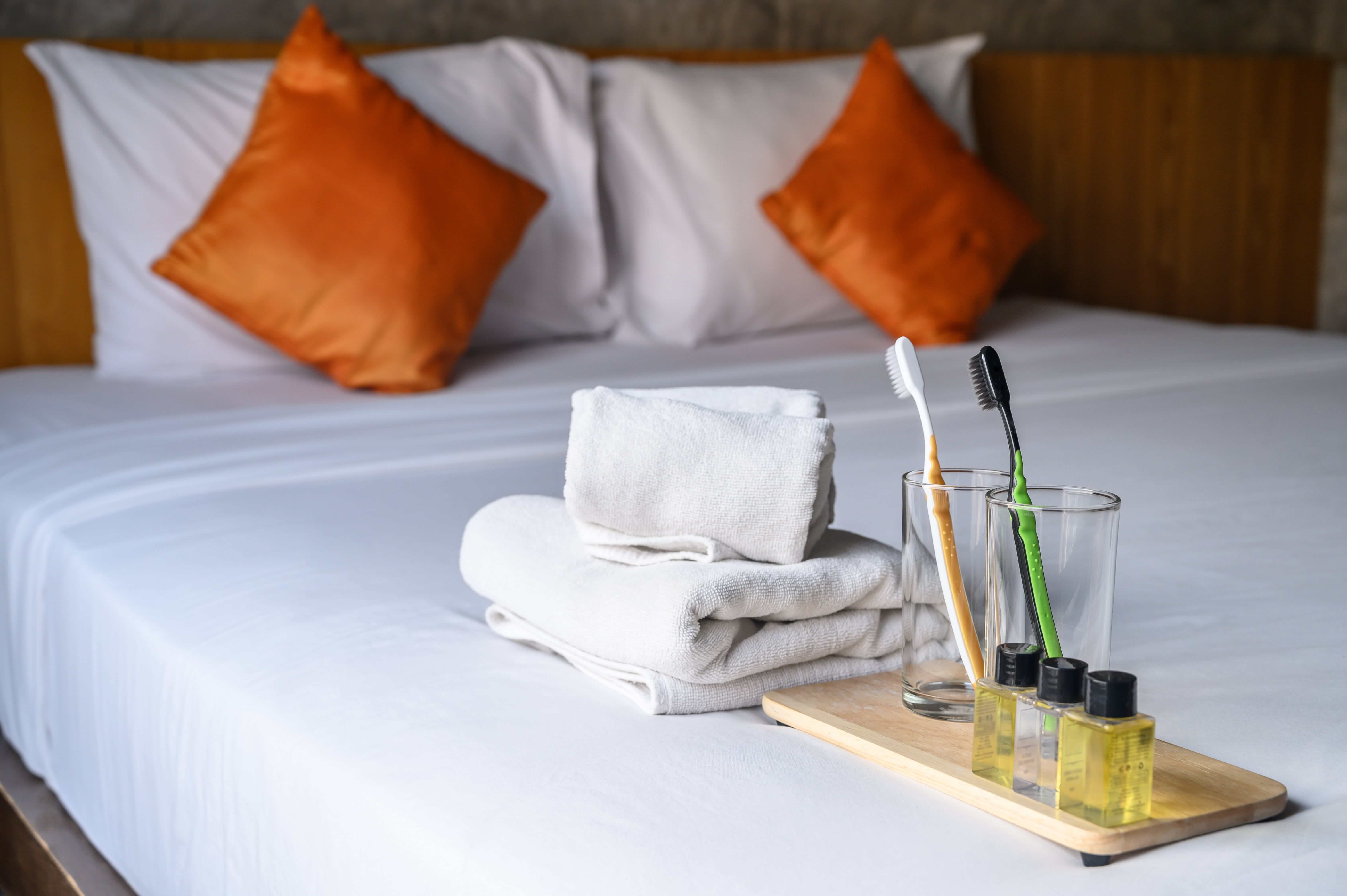 Towels, toothbrush and soap on guest bed