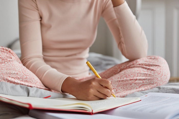 Woman writing in a sleep journal